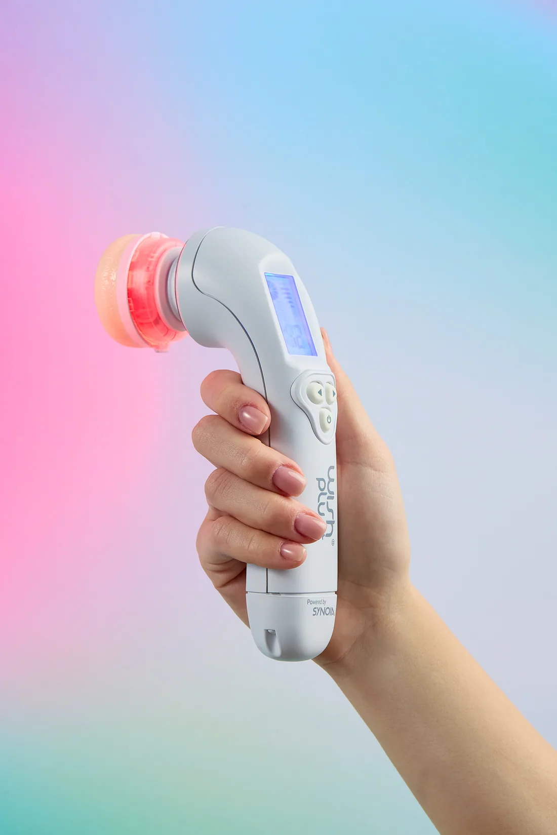 A WISHpro handpiece held in the hand, its technology head lit